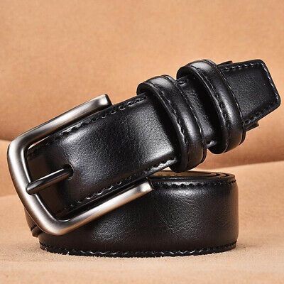 Black leather belt with a silver buckle on a beige background