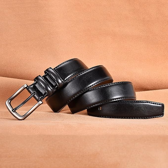 Black leather belt with a silver buckle on a beige background