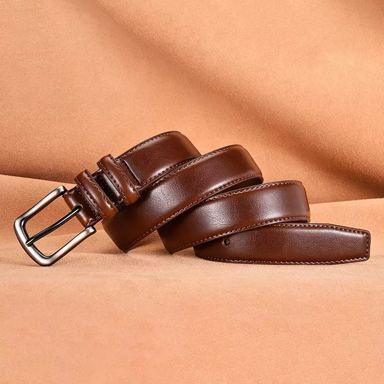 Brown leather belt with a silver buckle on a beige background
