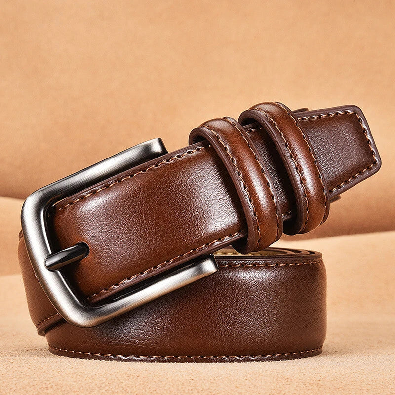 Brown leather belt with a silver buckle on a beige background